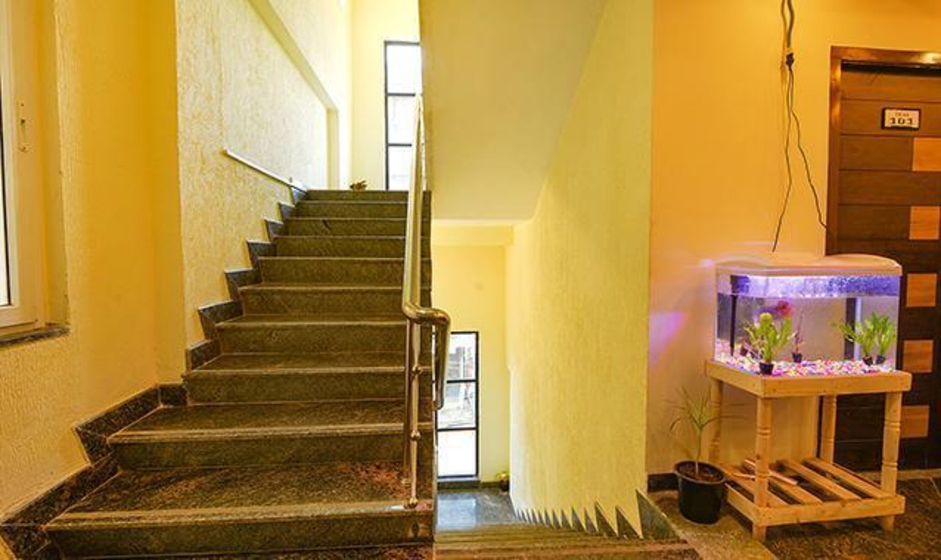 A staircase with a fish tank on the right.