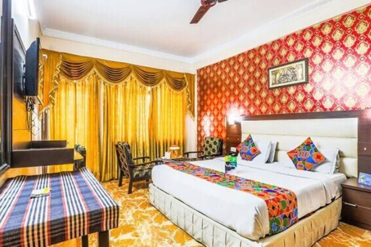 Una habitación de hotel con una cama, un escritorio y una silla.