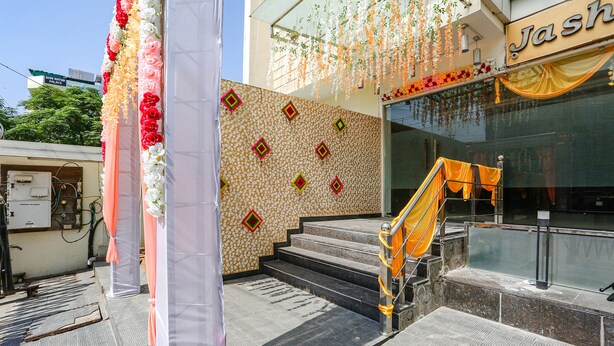 A hotel entrance with a patterned wall, a staircase, and a sign reading "Jash." - Fabhotel Mng (Kanpur)
