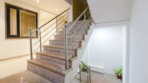 Eine Treppe mit Metallgeländern und einem Blumentopf am Fuß.