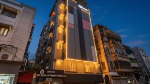 A multi-story hotel with a modern facade, illuminated windows, and a sign for 'Sayeeda International Hotel'. - Fabhotel Sayeeda International (Kolkata)