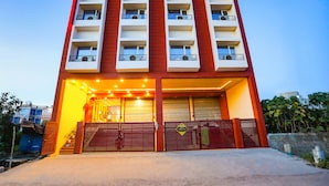 A hotel with multiple balconies, a sign for 'TRIJAL INN AC ROOMS & BANQUET', and a 'Fabexpress' sign. - FabHotel Trijal Inn (Lucknow)