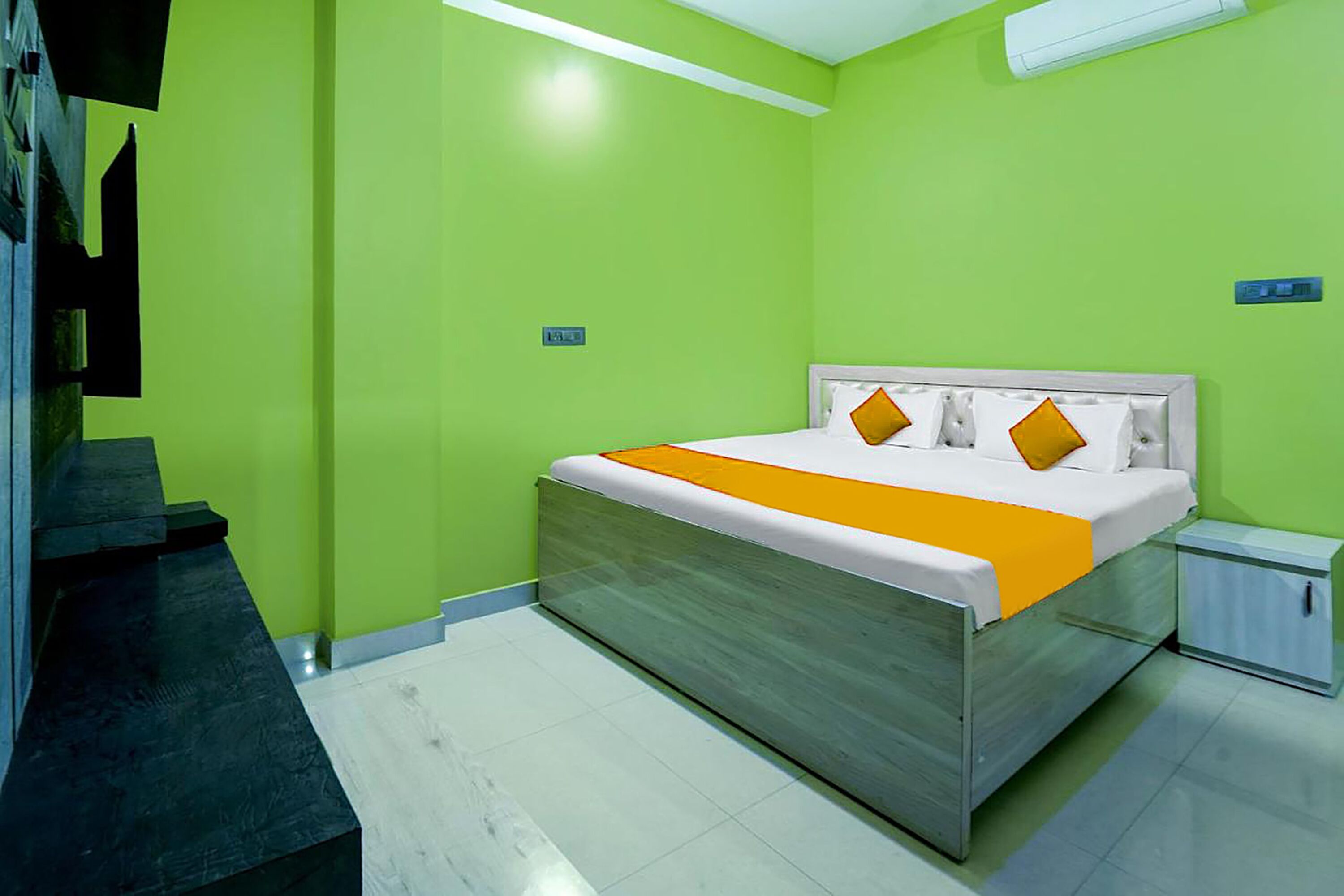 A modern bedroom with a bed, a nightstand, and a built-in bench.