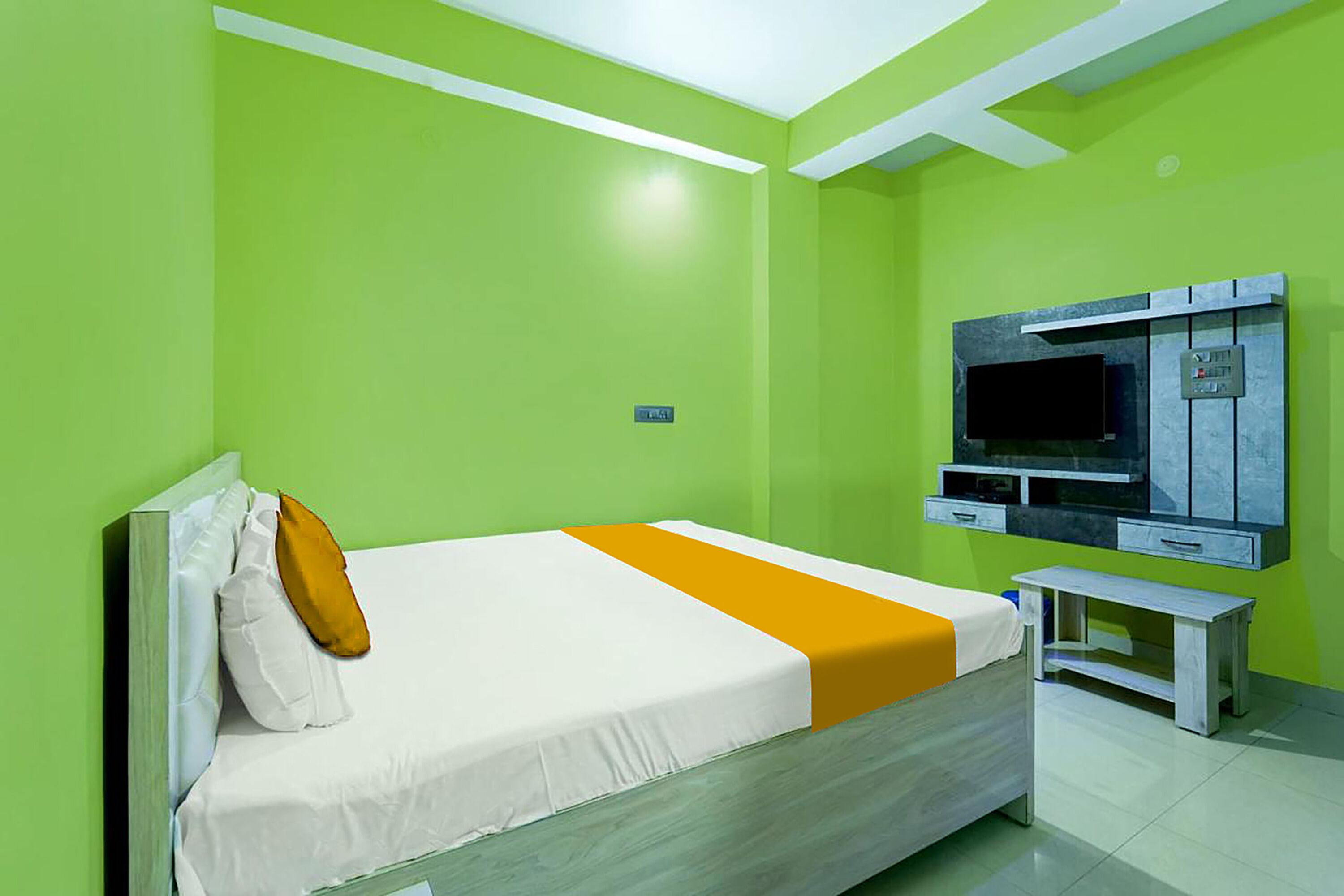 A room with a bed, a TV, and a small table.