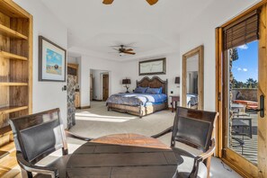 A bedroom with a bed, a ceiling fan, and a view of the outdoors through a sliding door. - Juniper Preserve (Pronghorn) | Golf & Mtn Views (Bend)