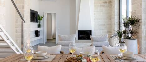 Deluxe Villa, Sea View | Living area | 55-inch Smart TV with satellite channels, fireplace