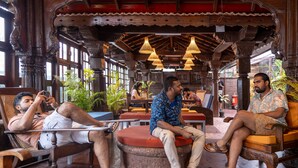A traditional wooden interior with seating arrangements and hanging lights.