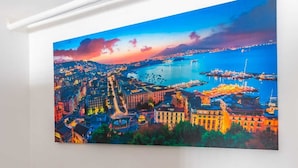 En målning som föreställer en stadsbild, målad på en vägg, en trappa med ett svart räcke och ett marmorgolv.