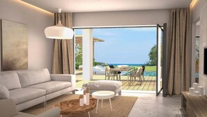 A modern living room with a sofa, coffee table, and a view of an outdoor deck and pool. - Natura Park Village Hotel & Spa  (Kos)