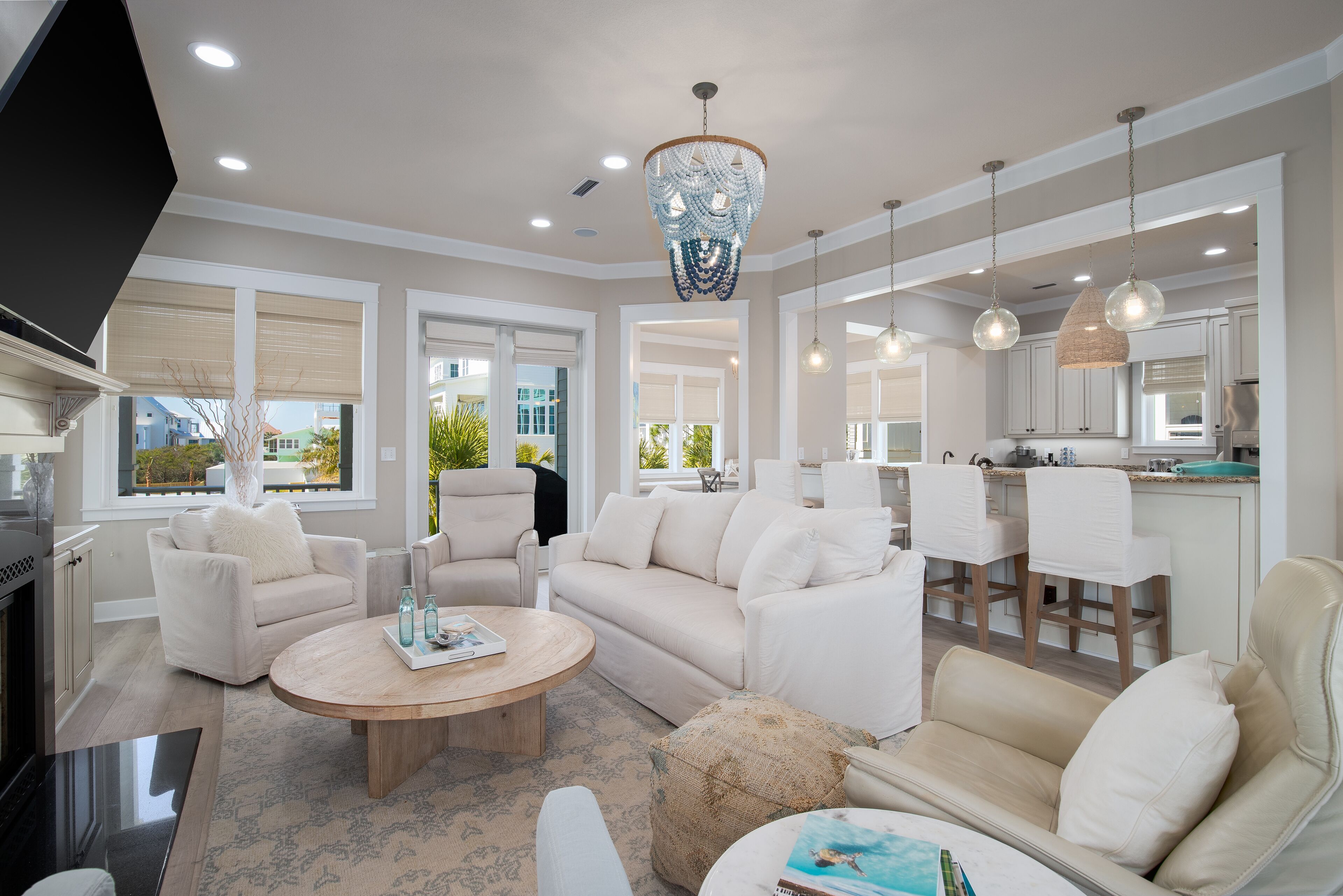 A spacious living room with a beige sofa set, a coffee table, and a TV.