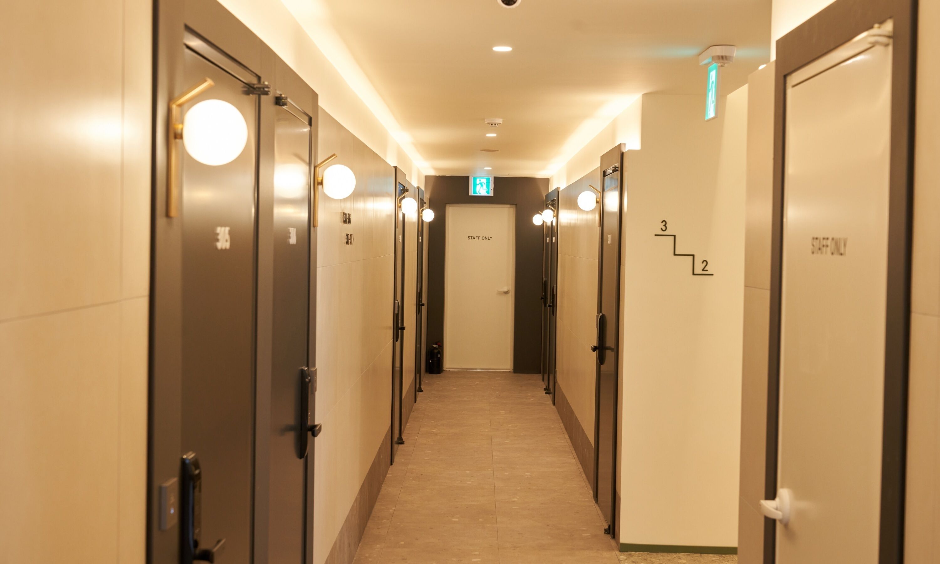 A hotel corridor with doors marked "STAFF ONLY" and numbered "3" and "2".