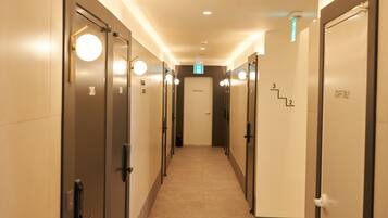 A hotel corridor with doors marked "STAFF ONLY" and numbered "3" and "2".