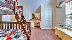 A bedroom with a bunk bed, a desk, and a chair in the corner. - Tagged Out Canal Front, Dock 3 bedroom 2 bath (St. George Island)