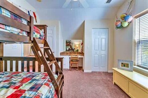 A bedroom with a bunk bed, a desk, and a chair in the corner. - Tagged Out Canal Front, Dock 3 bedroom 2 bath (St. George Island)