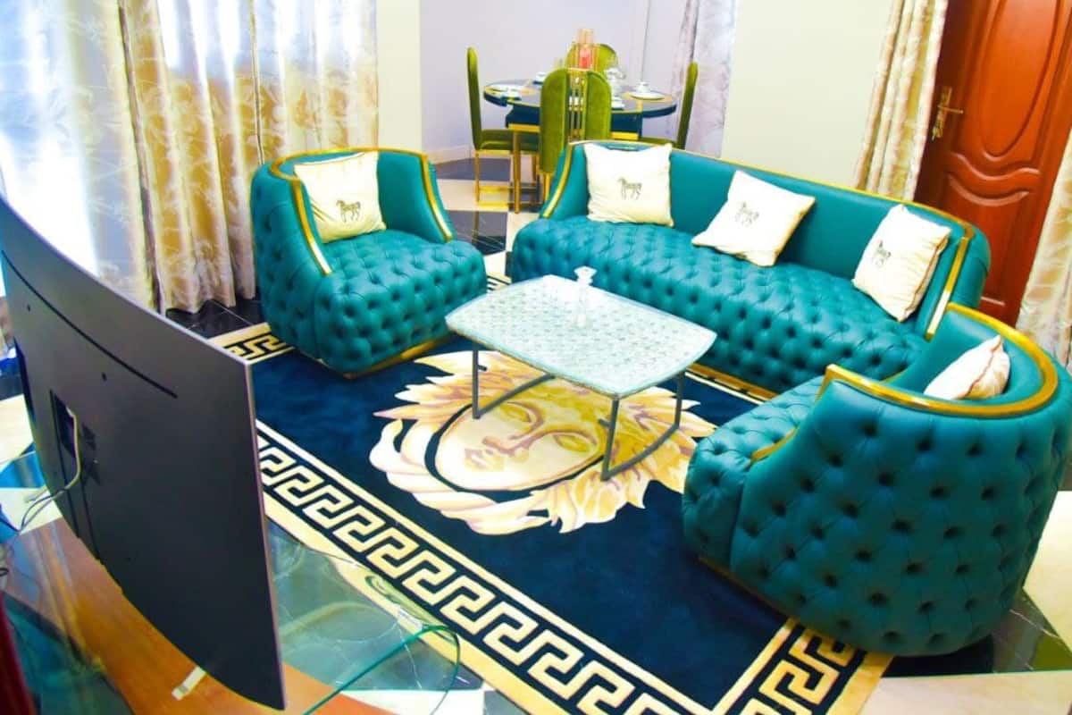 A living room with a sofa set, a coffee table, and a television.