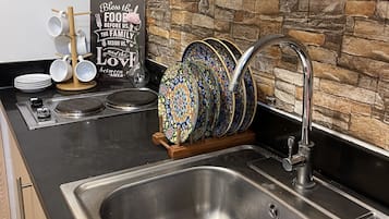 Fridge, stovetop, electric kettle, cookware/dishes/utensils