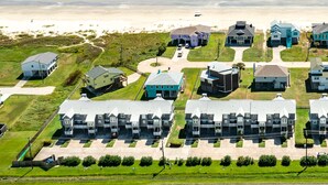 A coastal residential area with houses and a beach.