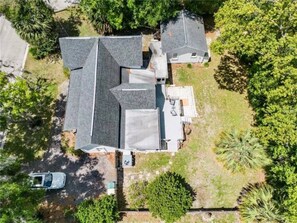 A residential property with a large house, a garage, and a driveway. - Morgan Cottage | Hot Tub & Historic Downtown Charm (Ocala)