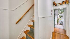 A staircase with wooden steps and a white wall. - 5 Mi to Salem: Furnished Patio at Danvers Studio! (Danvers)