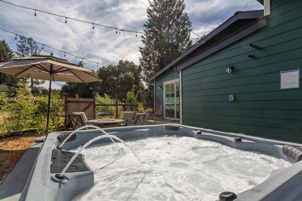 Unwind in the hot tub and soak up the peaceful backyard vibes.