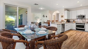 A modern kitchen with white cabinets, a stainless steel microwave, and a built-in oven. - Honu Harmony Pools, Golf Privileges, & More (Waikoloa)