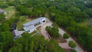 A modern house surrounded by dense greenery, with a clear view of the surrounding landscape. - Stunning 'Ranch Modern' + Stars! + Firepit! (Driftwood)