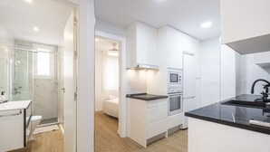 A modern kitchen with white cabinetry, a black countertop, and a built-in oven. - Alameda 16-3 Apartment Beach-Old Town (Benidorm)