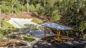 A set of outdoor stairs leading up a hill, surrounded by trees, with a wooden gazebo at the top. - Pilot Cove Forest Lodging (Pisgah Forest)