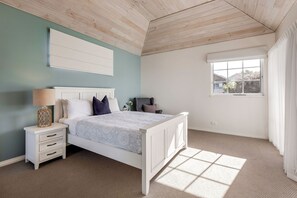 A bedroom with a bed, nightstand, and window. - Hampton House in Old Dunsborough (Dunsborough)