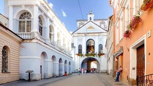 A historic building with arched windows and a central entrance. - Luxury apartments 3 (Vilnius)