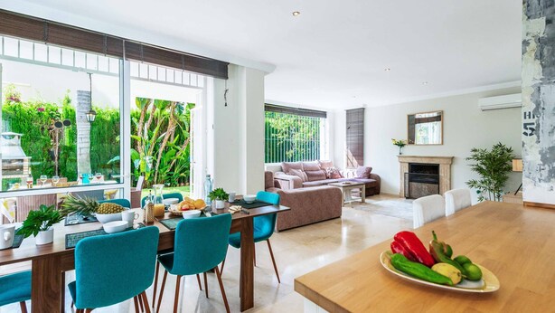 A modern kitchen with a dining area, large windows, and a fireplace. - Villa Moongate - Three Bedroom Villa, Sleeps 6 (Calahonda)