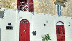 Un edificio con puerta roja, una planta en maceta y un letrero que dice "Harbour Nook 89".