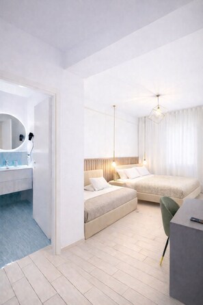 A modern hotel room with a large bed, a desk, and a bathroom with a mirror and sink. - Vomerooms (Naples)