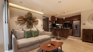 A modern living room with a sofa, coffee table, and a decorative wall piece.