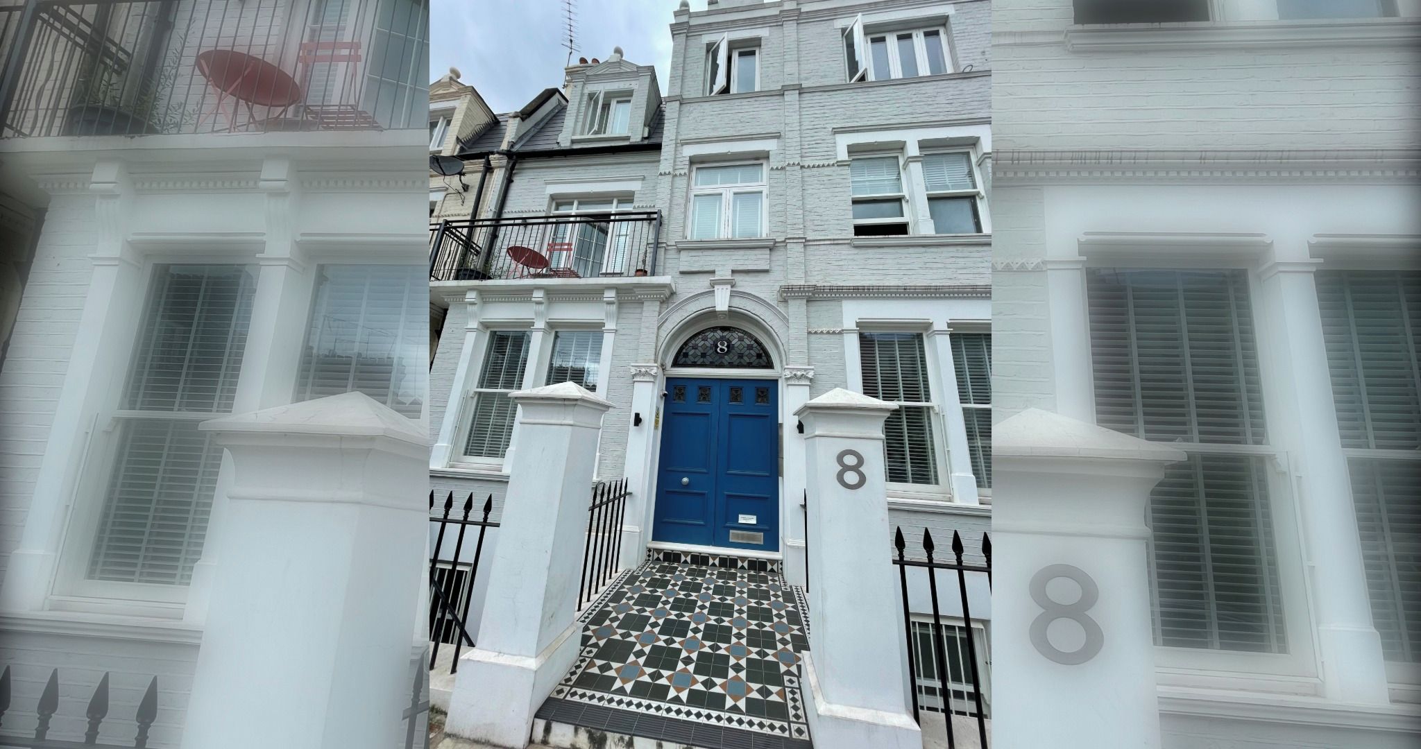 A traditional building with a blue door, white walls, and a number '8' on the facade.