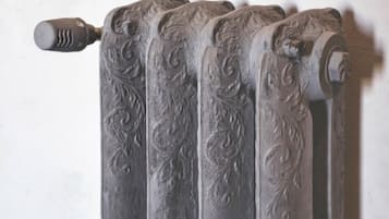 A radiator with intricate scrollwork design.
