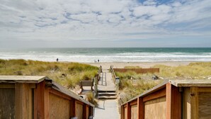 A wooden boardwalk leading to a beach with a clear sky. - Oceanfront Watsonville Condo w/ Beach Access! (Watsonville)