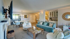A modern living room with a sofa, coffee table, and dining area. - Oceanfront Watsonville Condo w/ Beach Access! (Watsonville)