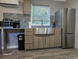 Fridge, microwave, coffee/tea maker, cookware/dishes/utensils