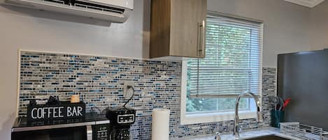 Fridge, microwave, coffee/tea maker, cookware/dishes/utensils