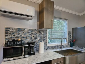 Fridge, microwave, coffee/tea maker, cookware/dishes/utensils