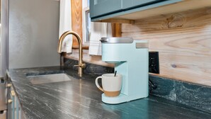 A kitchen with a coffee maker, a sink, and a wooden countertop. - The Hendo - Cabin #1 - Studio Style (Henderson)