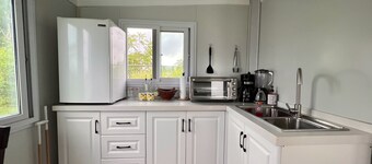 Comfy and cozy mini house sitting on a beautiful 1500 meter lot. Great location!