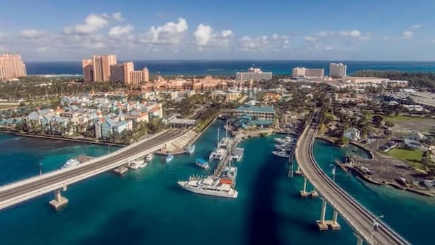 An aerial view of a coastal city with a marina, high-rise buildings, and a bridge. - Located on Paradise Island, Bahamas, close to the Atlantis Resort and beach.  (Nassau)