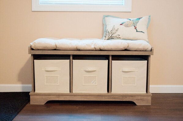A storage bench with three drawers and a cushioned seat.