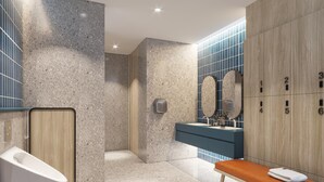 A modern bathroom with a marble floor, a wooden bench, a sink with a blue countertop, and a mirror with a stone frame. - Holiday Inn Express Rayong by IHG (Rayong)