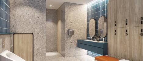 Un baño moderno con suelo de mármol, un banco de madera, un lavabo con encimera azul y un espejo con marco de piedra.
