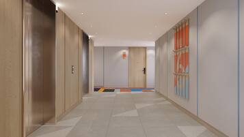 A hallway with a tiled floor, wooden doors, and a door with a colorful design.