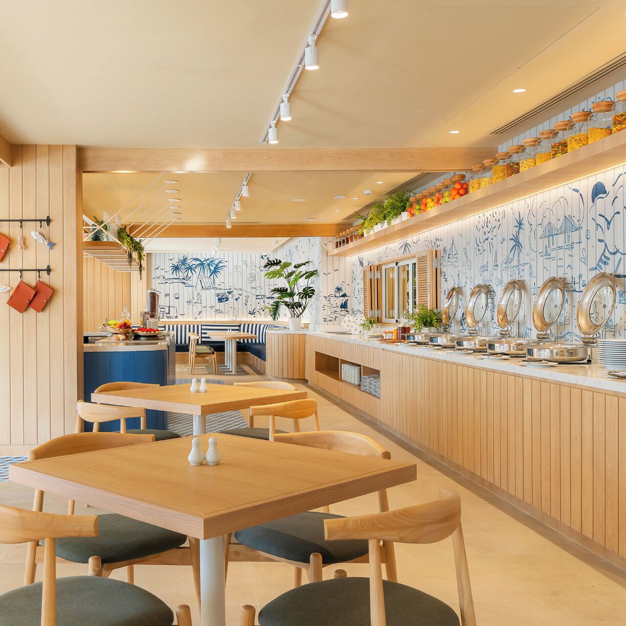 A restaurant with wooden paneling, a counter with food containers, and a seating area with tables and chairs.