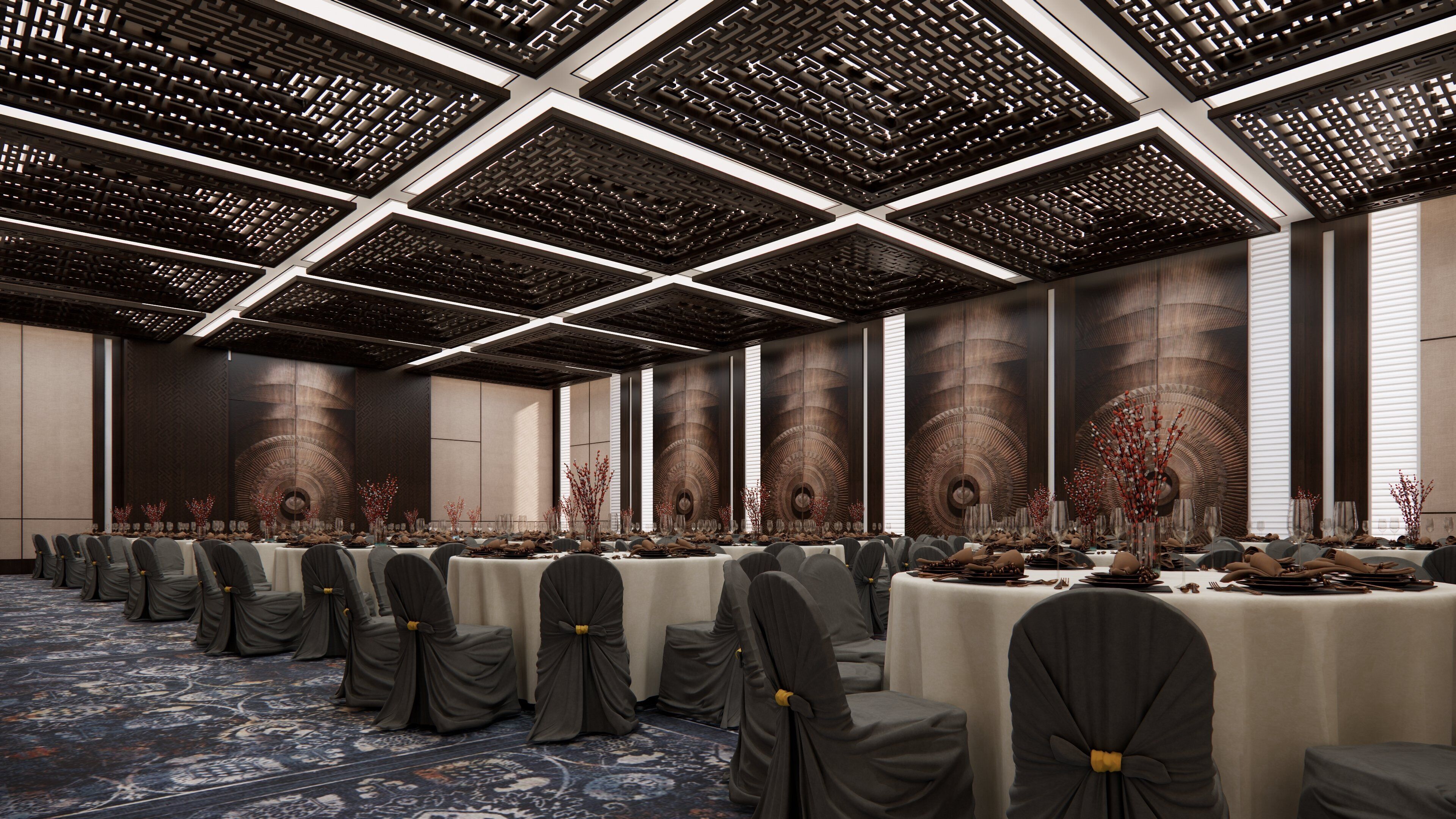 A conference room with a long table, chairs, and a patterned carpet.